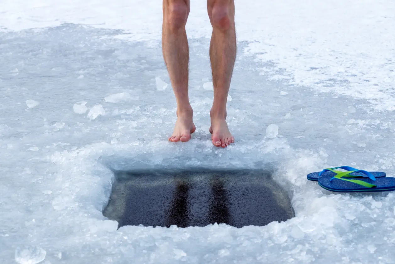 man standing outside ice hole contrast therapy